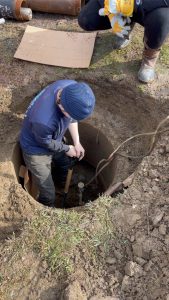 Working on a submersible well pump in a pit