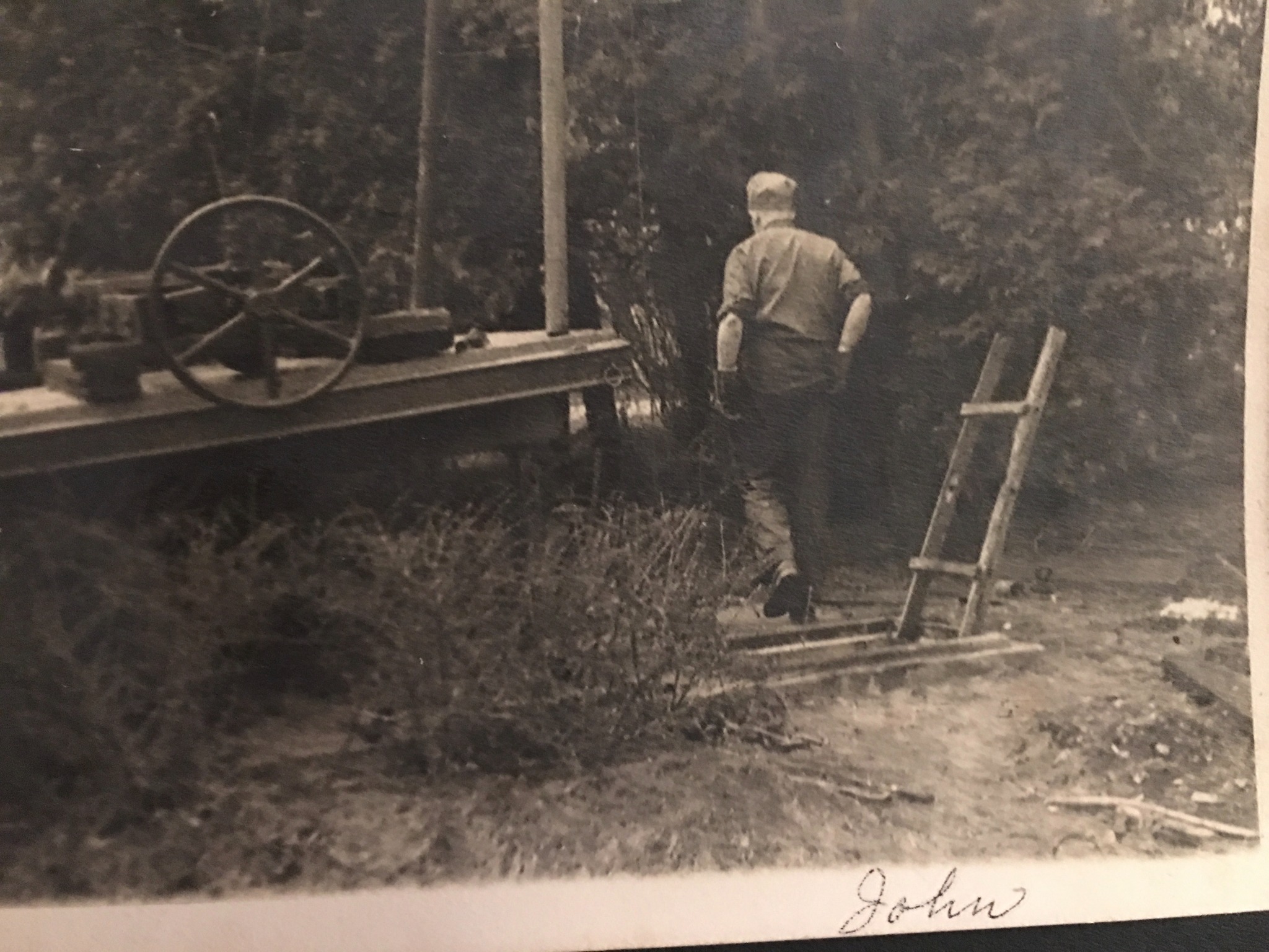 John Boyd beside an early wooden well-drilling rig